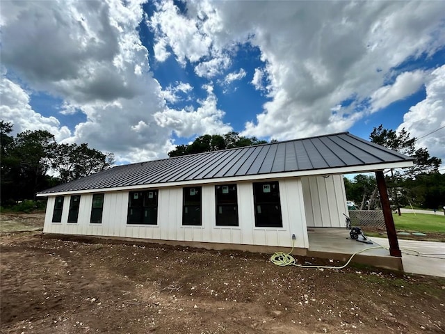 1127 Greenhill Dr, Canyon Lake, TX 78133 - rear view of property featuring board and batten siding, a standing seam roof, and a metal roof