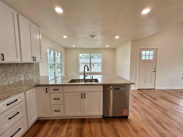 1127 Greenhill Dr, Canyon Lake, TX 78133 - kitchen with dishwasher, a peninsula, light wood-style floors, white cabinetry, and healthy amount of natural light