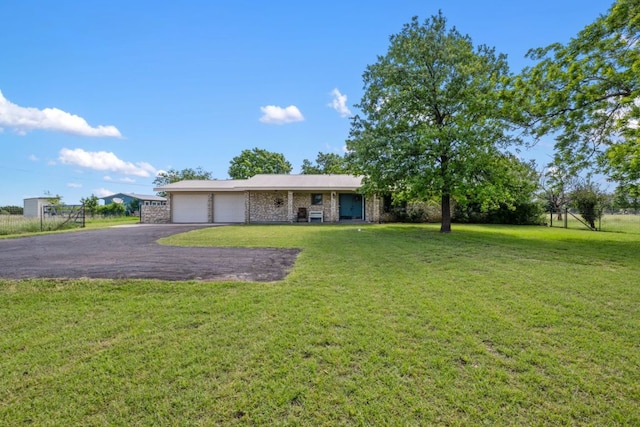 401 Patriot Way, Georgetown, TX 78626 - view of front facade with a front yard, asphalt driveway, an attached garage, and brick siding