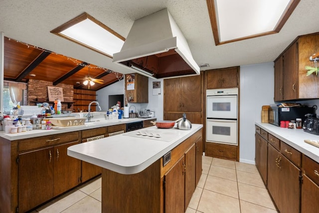 401 Patriot Way, Georgetown, TX 78626 - kitchen with black appliances, range hood, light countertops, a sink, and a center island
