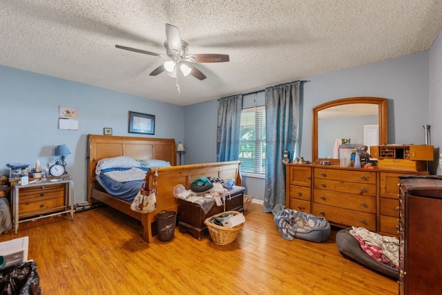 401 Patriot Way, Georgetown, TX 78626 - bedroom featuring wood finished floors, a textured ceiling, and a ceiling fan