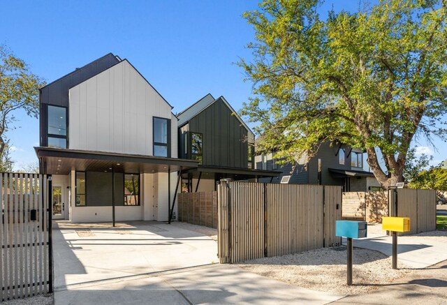 613 Clifford Dr Unit B, Austin, TX 78745 - view of front of home with a gate, board and batten siding, fence, and concrete driveway