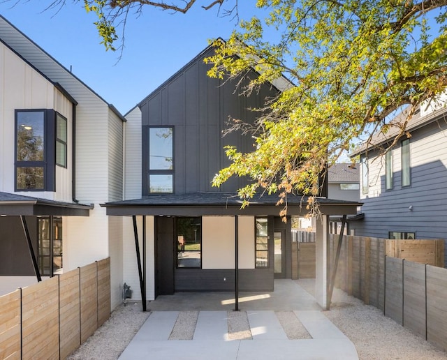 613 Clifford Dr Unit B, Austin, TX 78745 - back of house with board and batten siding, a patio area, and a fenced backyard