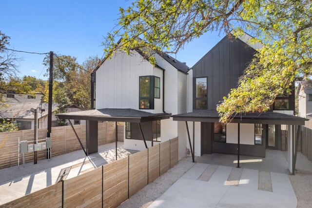 613 Clifford Dr Unit B, Austin, TX 78745 - back of house with board and batten siding, a fenced backyard, and a patio
