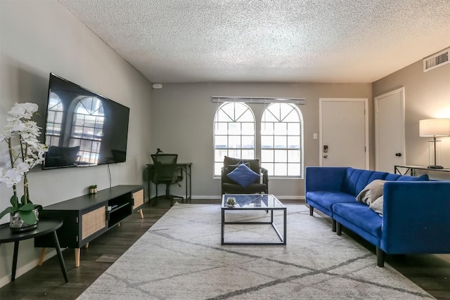 101 E 33rd St Unit 107, Austin, TX 78705 - living room featuring a textured ceiling, wood finished floors, and baseboards