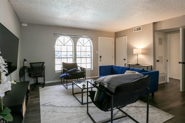 101 E 33rd St Unit 107, Austin, TX 78705 - living area featuring a textured ceiling, wood finished floors, baseboards, and an office area