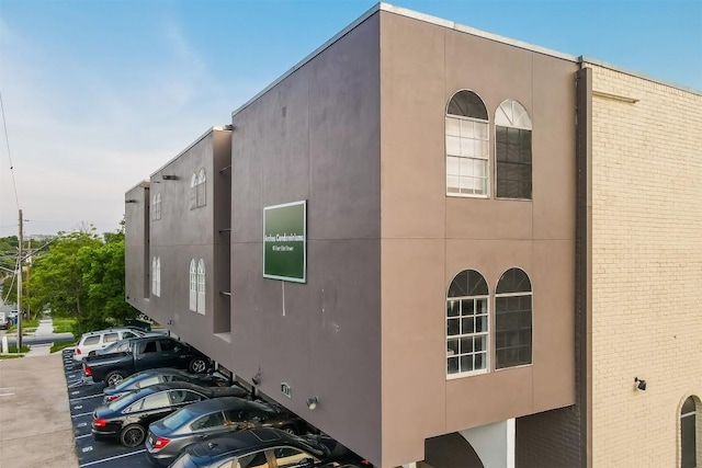 101 E 33rd St Unit 107, Austin, TX 78705 - view of side of property with uncovered parking and brick siding