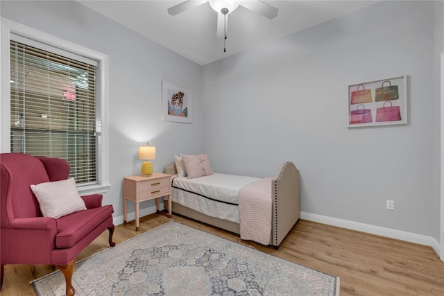 101 W Bank Unit 43, Llano, TX 78657 - bedroom featuring baseboards, wood finished floors, and a ceiling fan