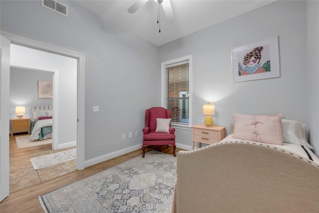101 W Bank Unit 43, Llano, TX 78657 - bedroom featuring wood finished floors, baseboards, and ceiling fan