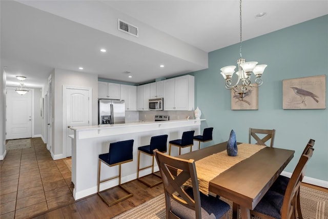 101 W Bank Unit 43, Llano, TX 78657 - dining area with baseboards, recessed lighting, a chandelier, and wood finished floors