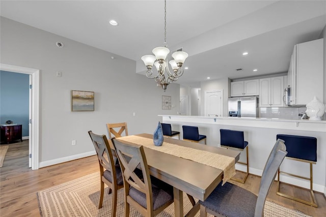 101 W Bank Unit 43, Llano, TX 78657 - dining area featuring a chandelier, light wood-style flooring, recessed lighting, and baseboards