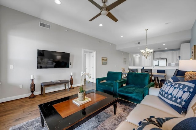101 W Bank Unit 43, Llano, TX 78657 - living area featuring wood finished floors, ceiling fan, baseboards, a chandelier, and recessed lighting