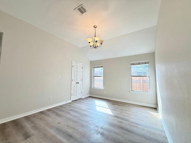 4233 Fairmeadow Dr, Round Rock, TX 78665 - empty room with a chandelier, baseboards, wood finished floors, and vaulted ceiling