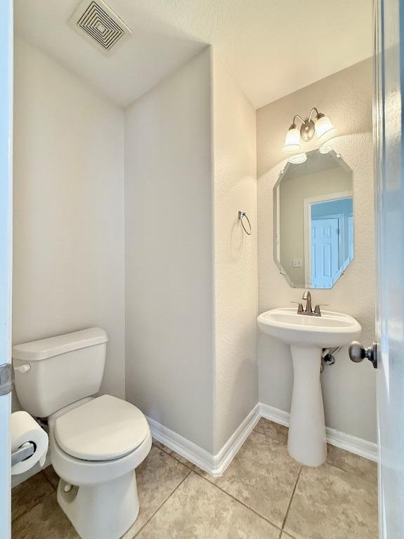 4233 Fairmeadow Dr, Round Rock, TX 78665 - half bathroom with toilet, tile patterned flooring, baseboards, and a sink