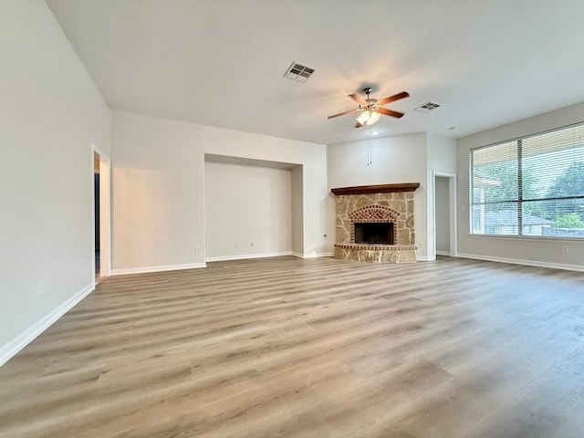 4233 Fairmeadow Dr, Round Rock, TX 78665 - unfurnished living room featuring a ceiling fan, baseboards, light wood-style floors, and a fireplace