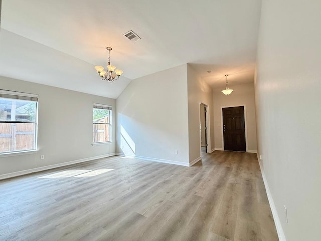4233 Fairmeadow Dr, Round Rock, TX 78665 - spare room with a chandelier, light wood-style floors, baseboards, and lofted ceiling