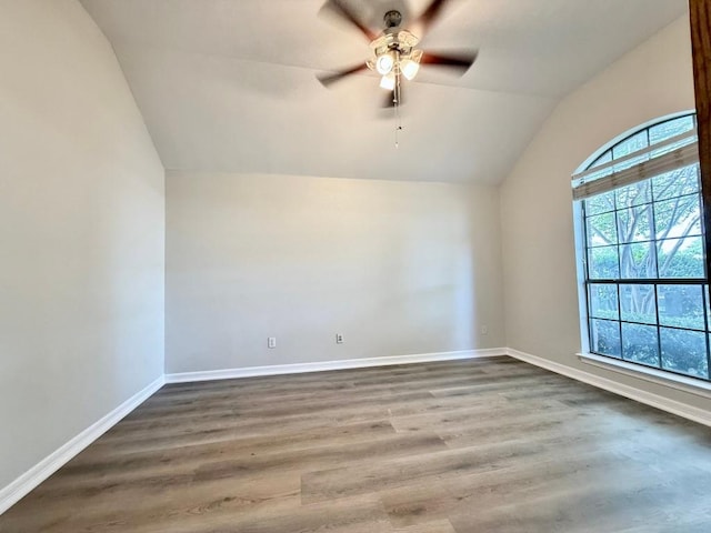 4233 Fairmeadow Dr, Round Rock, TX 78665 - spare room featuring vaulted ceiling, a ceiling fan, baseboards, and wood finished floors