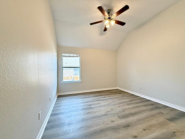 4233 Fairmeadow Dr, Round Rock, TX 78665 - spare room with a ceiling fan, wood finished floors, lofted ceiling, baseboards, and a textured wall
