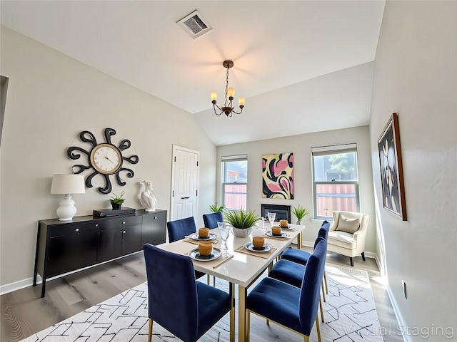 4233 Fairmeadow Dr, Round Rock, TX 78665 - dining room featuring a chandelier, light wood-type flooring, baseboards, and vaulted ceiling
