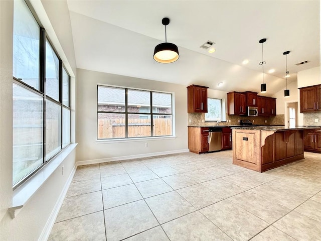 4233 Fairmeadow Dr, Round Rock, TX 78665 - kitchen with vaulted ceiling, appliances with stainless steel finishes, tasteful backsplash, a kitchen bar, and dark countertops
