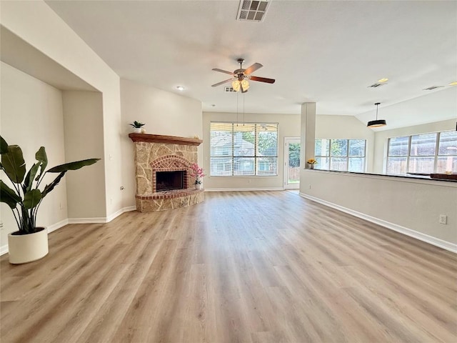4233 Fairmeadow Dr, Round Rock, TX 78665 - unfurnished living room with baseboards, wood finished floors, a ceiling fan, and a stone fireplace