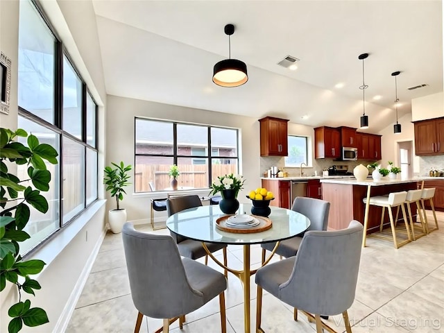 4233 Fairmeadow Dr, Round Rock, TX 78665 - dining area featuring baseboards, light tile patterned flooring, and vaulted ceiling
