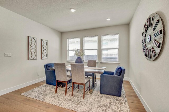 991 Arrowhead Ranch Blvd, Dripping Springs, TX 78620 - dining area with wood finished floors, baseboards, a textured ceiling, and recessed lighting