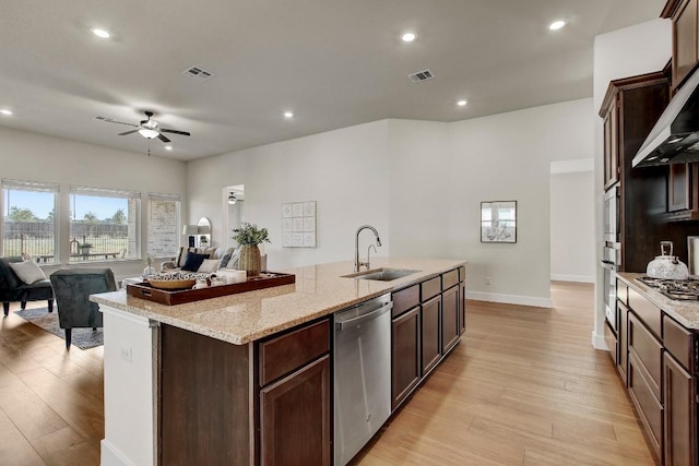 991 Arrowhead Ranch Blvd, Dripping Springs, TX 78620 - kitchen with a sink, stainless steel appliances, ceiling fan, light wood-style flooring, and open floor plan