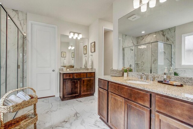 991 Arrowhead Ranch Blvd, Dripping Springs, TX 78620 - bathroom featuring a marble finish shower, marble finish floors, and two vanities