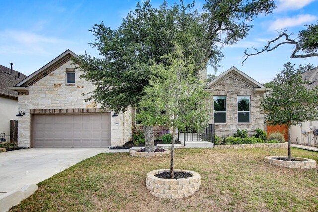 991 Arrowhead Ranch Blvd, Dripping Springs, TX 78620 - view of front of home featuring a front yard, driveway, and stone siding