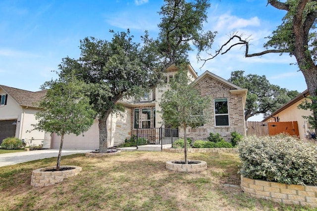 991 Arrowhead Ranch Blvd, Dripping Springs, TX 78620 - view of property hidden behind natural elements with driveway and an attached garage