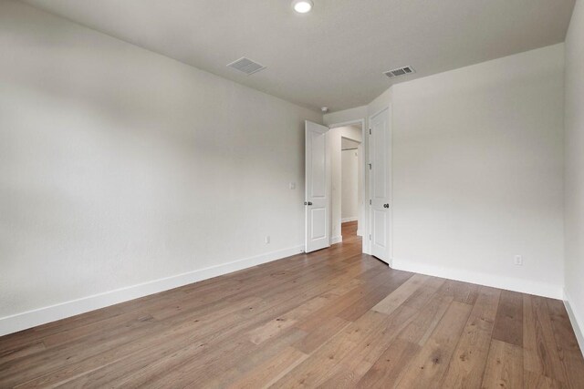 991 Arrowhead Ranch Blvd, Dripping Springs, TX 78620 - unfurnished room with baseboards, wood finished floors, and recessed lighting