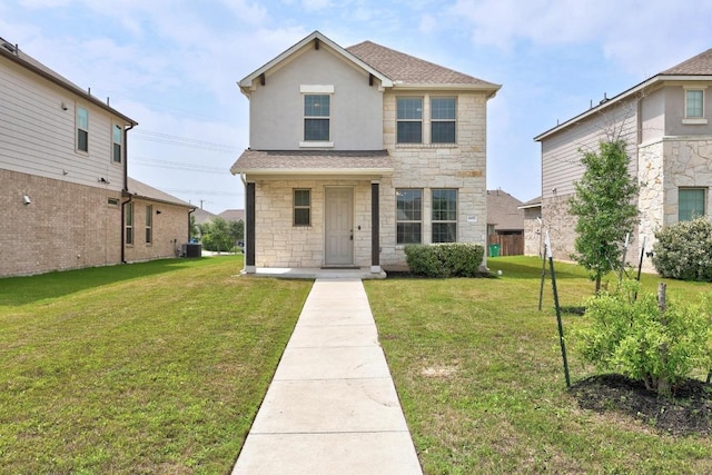 traditional-style home with stone siding, a front yard, central AC unit, and roof with shingles