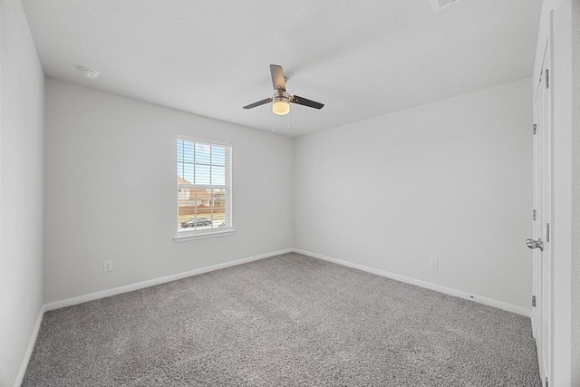 spare room with a ceiling fan, carpet floors, and baseboards