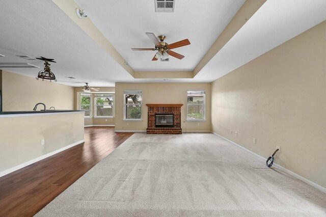 5705 Marchmont Ln, Austin, TX 78749 - unfurnished living room with a ceiling fan, baseboards, a fireplace, and carpet floors