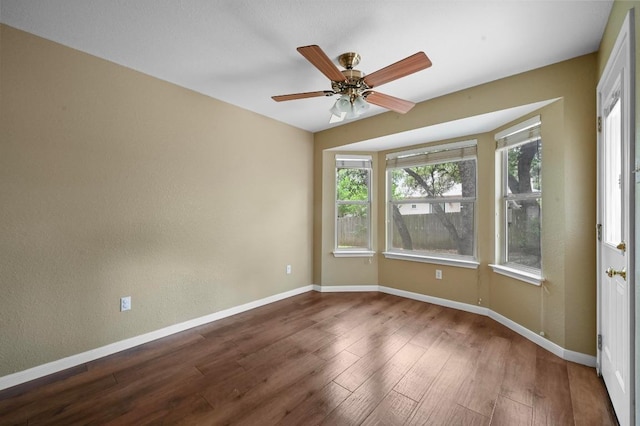 5705 Marchmont Ln, Austin, TX 78749 - empty room featuring wood finished floors, baseboards, and a ceiling fan