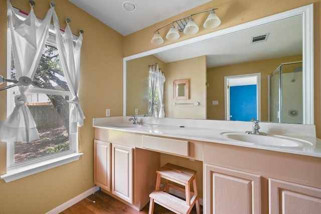 5705 Marchmont Ln, Austin, TX 78749 - full bath with a shower stall, baseboards, double vanity, and wood finished floors