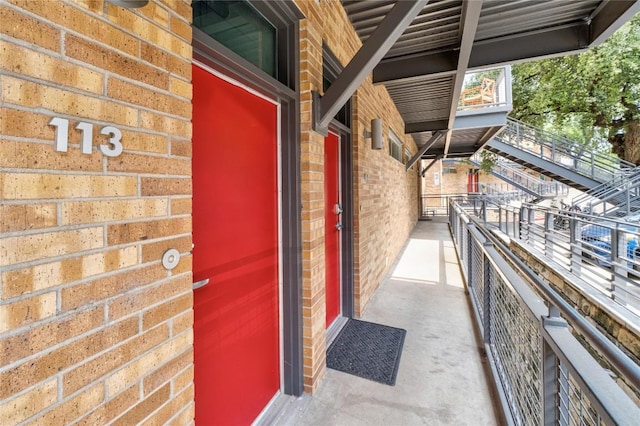 view of exterior entry featuring brick siding