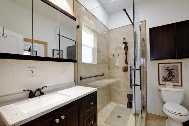 472 Mountain View Dr, Bandera, TX 78003 - bathroom with a stall shower, toilet, vanity, and tile patterned flooring