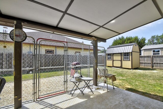 472 Mountain View Dr, Bandera, TX 78003 - view of patio / terrace with a gate, an outbuilding, and a shed