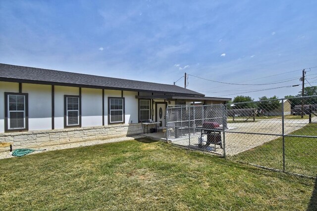 472 Mountain View Dr, Bandera, TX 78003 - rear view of house with stucco siding, a shingled roof, stone siding, and a patio area