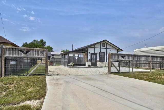 472 Mountain View Dr, Bandera, TX 78003 - view of front of house with a gate and stone siding