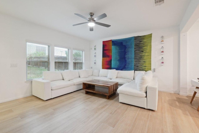 1107 Cadence Dr, Pflugerville, TX 78660 - living area with ceiling fan, light wood-style floors, and baseboards
