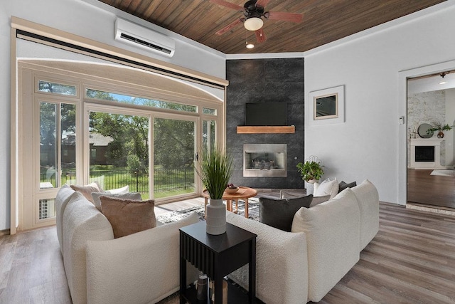 225 Cimarron Hills Trl E, Georgetown, TX 78628 - living room featuring a large fireplace, wooden ceiling, a wall mounted AC, ceiling fan, and wood finished floors