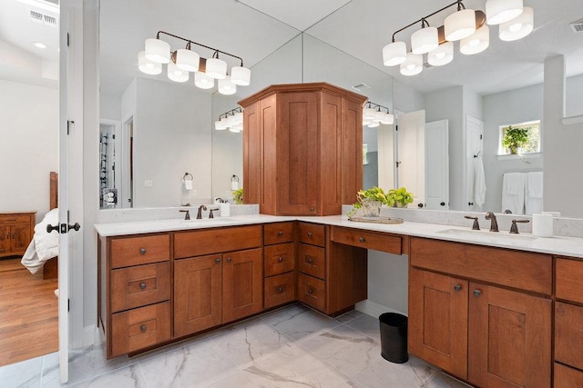 225 Cimarron Hills Trl E, Georgetown, TX 78628 - ensuite bathroom with double vanity and marble finish flooring