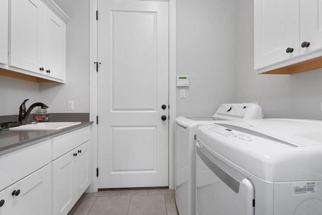 225 Cimarron Hills Trl E, Georgetown, TX 78628 - laundry room featuring cabinet space, washer and dryer, and light tile patterned floors