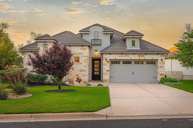 225 Cimarron Hills Trl E, Georgetown, TX 78628 - view of front facade with stone siding, a front lawn, concrete driveway, and an attached garage
