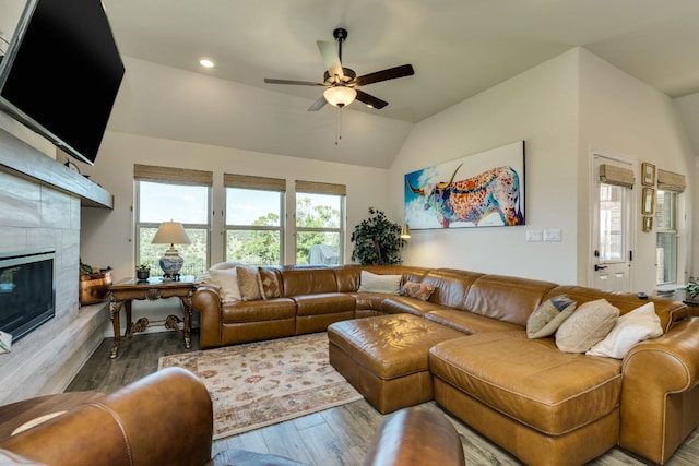 22208 Coyote Cave Trl, Spicewood, TX 78669 - living room with a ceiling fan, wood finished floors, a fireplace, vaulted ceiling, and recessed lighting