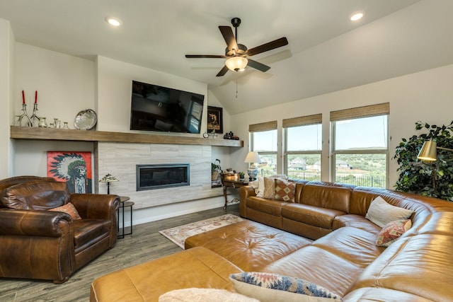 22208 Coyote Cave Trl, Spicewood, TX 78669 - living room featuring a ceiling fan, wood finished floors, a high end fireplace, recessed lighting, and vaulted ceiling