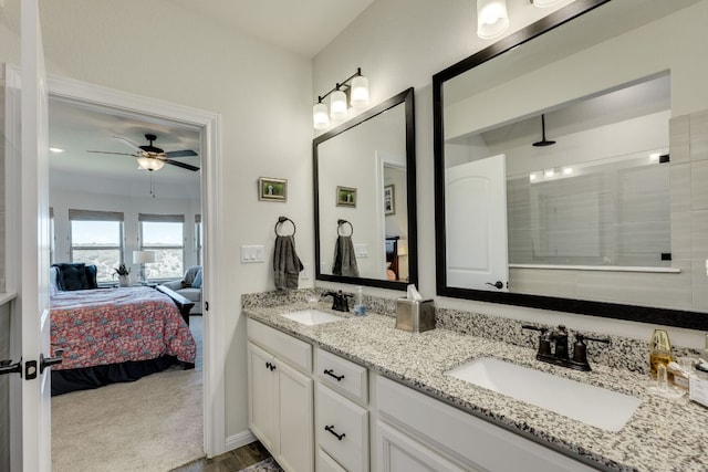 22208 Coyote Cave Trl, Spicewood, TX 78669 - bathroom featuring ensuite bath, double vanity, ceiling fan, and a tile shower